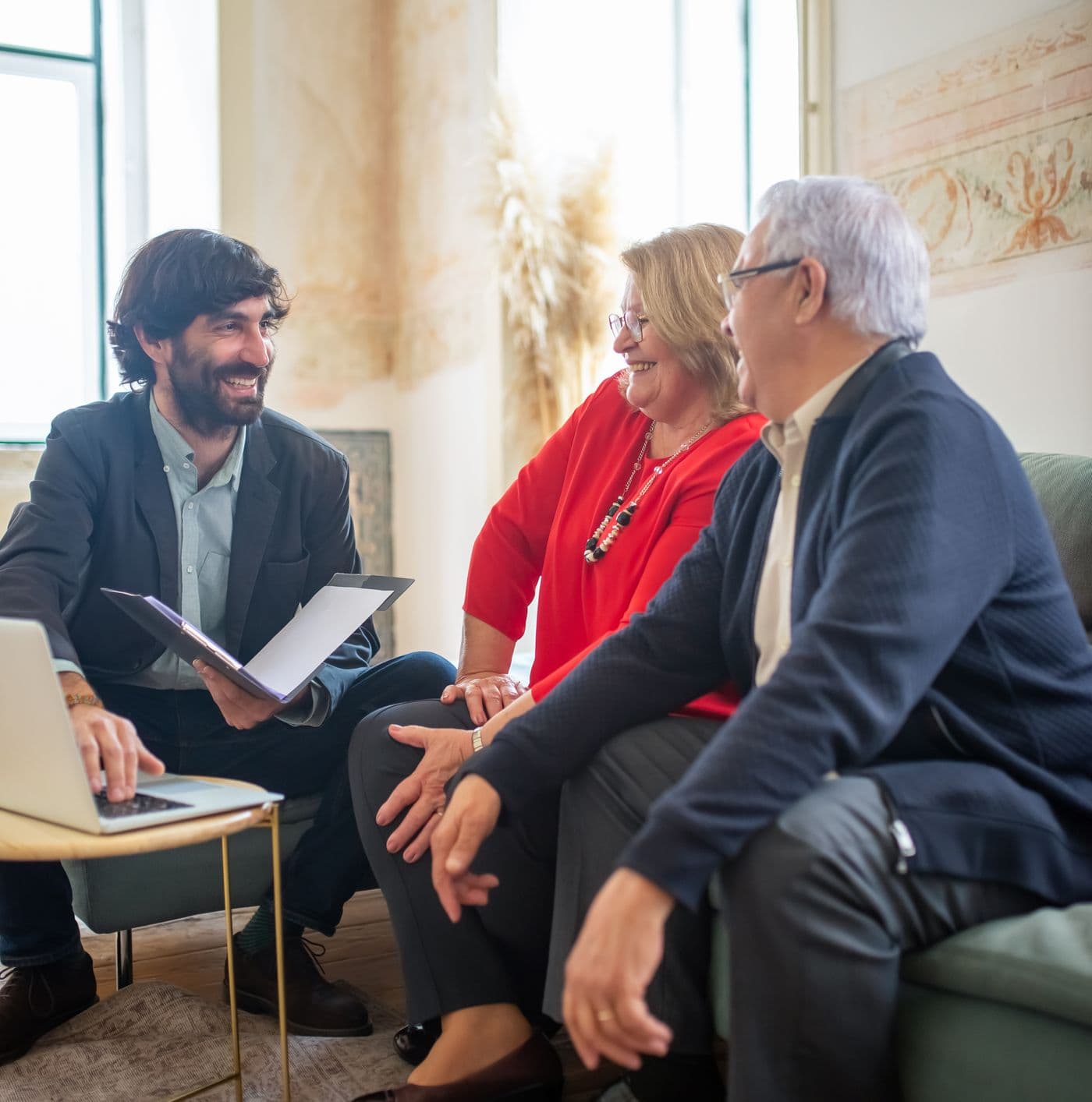 A licensed advisor reviewing a retirement income plan with an older couple at home